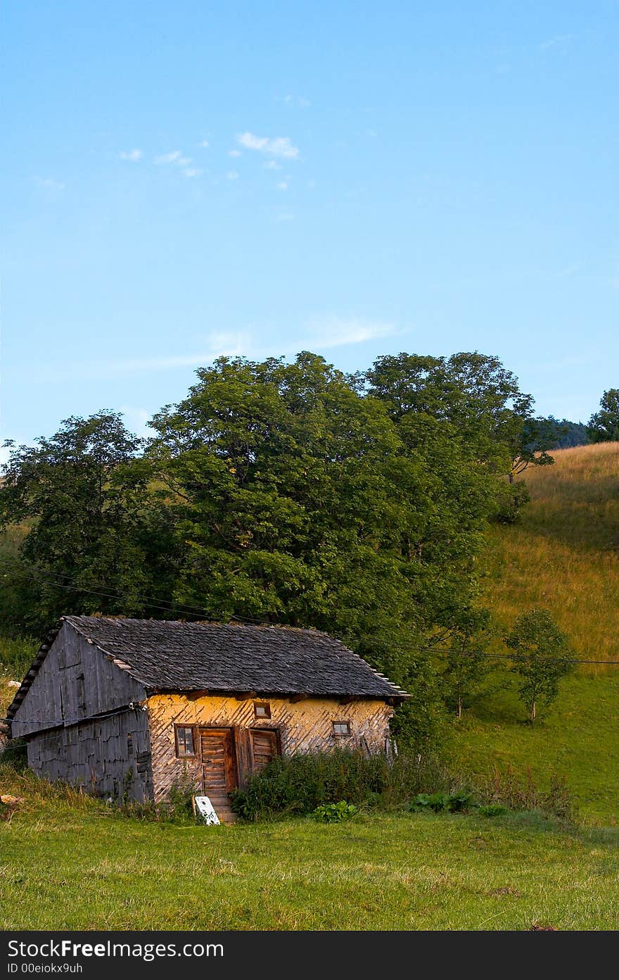 Old house on the hill in the summer