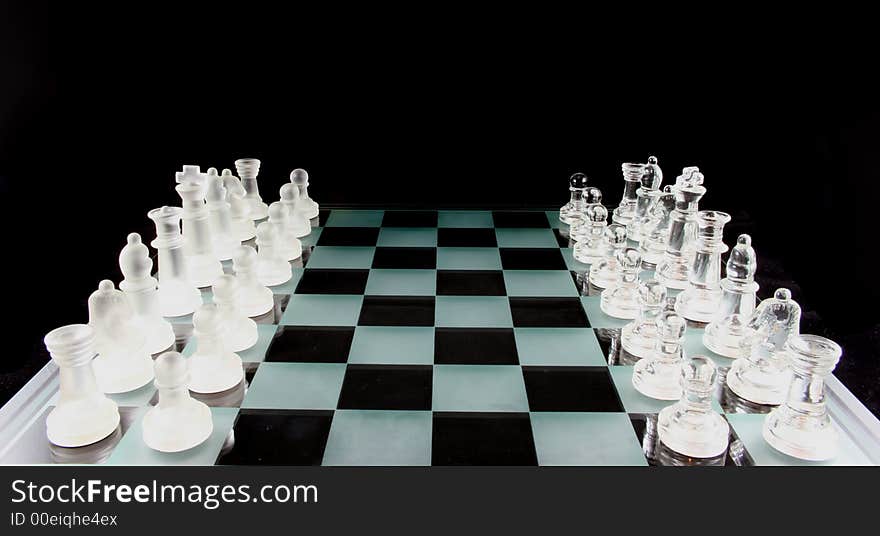 Glass Chess Pieces on a Frosted Glass Chess Board. Glass Chess Pieces on a Frosted Glass Chess Board