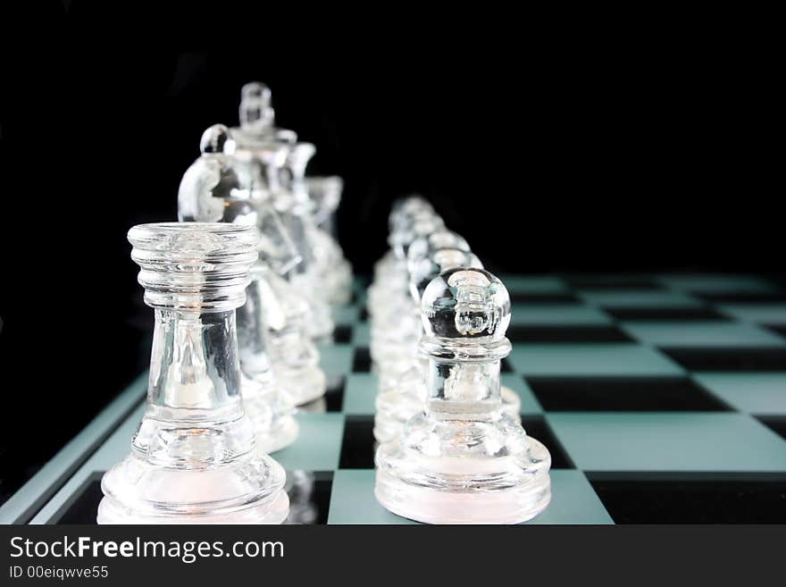 Glass Chess Pieces on a Frosted Glass Chess Board. Glass Chess Pieces on a Frosted Glass Chess Board