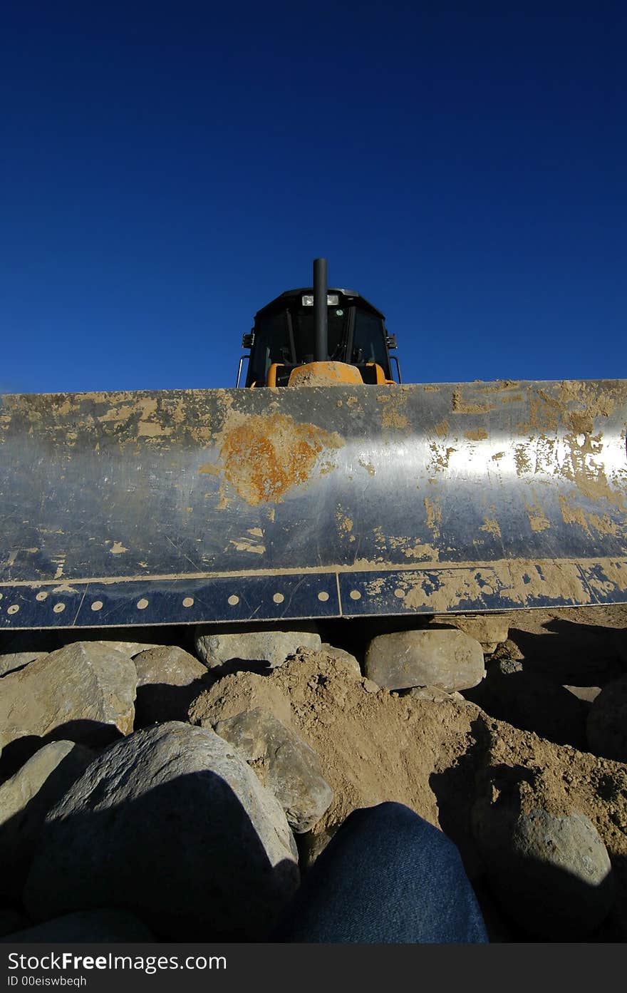 Bulldozer at construction site with blue sky