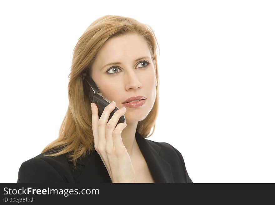 A businesswoman in a suit uses a cell phone. A businesswoman in a suit uses a cell phone