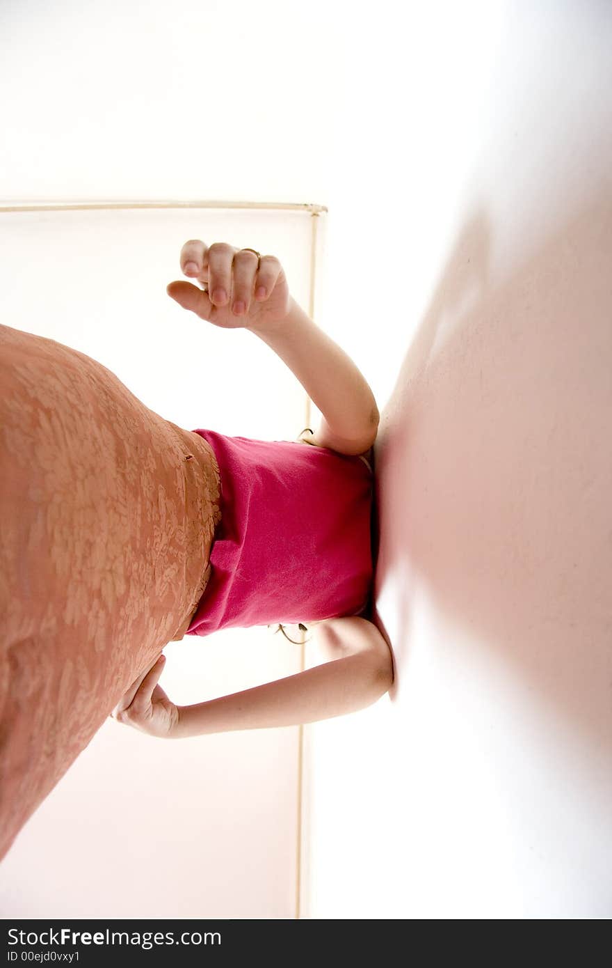 Girl standing near the wall in the morning.