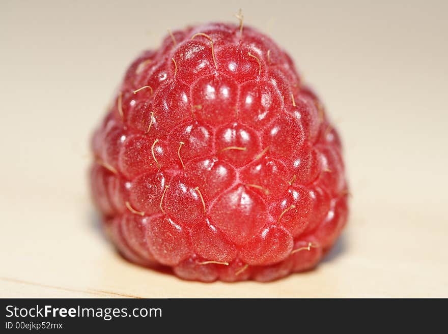 One raspberry on the table