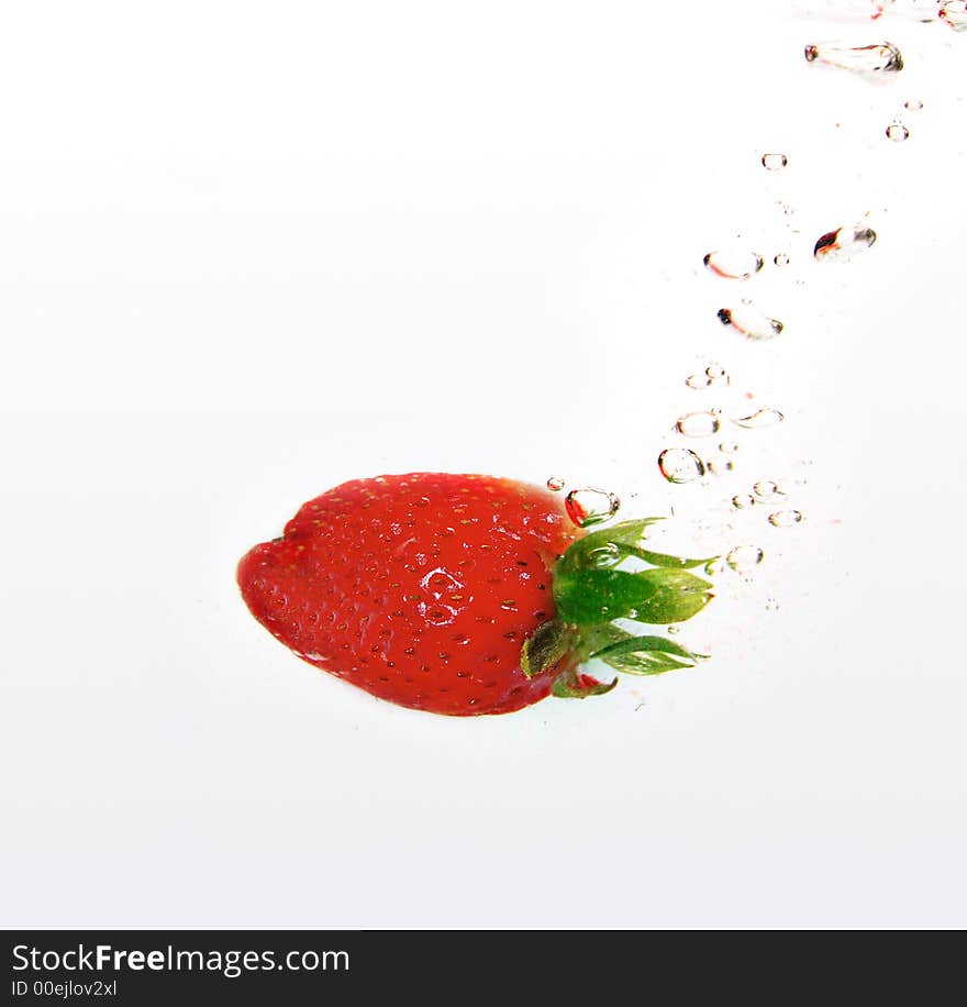 Water drops and strawberries in water. Water drops and strawberries in water