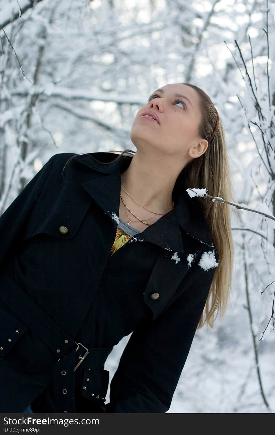 Girl in black coat looking up. Girl in black coat looking up