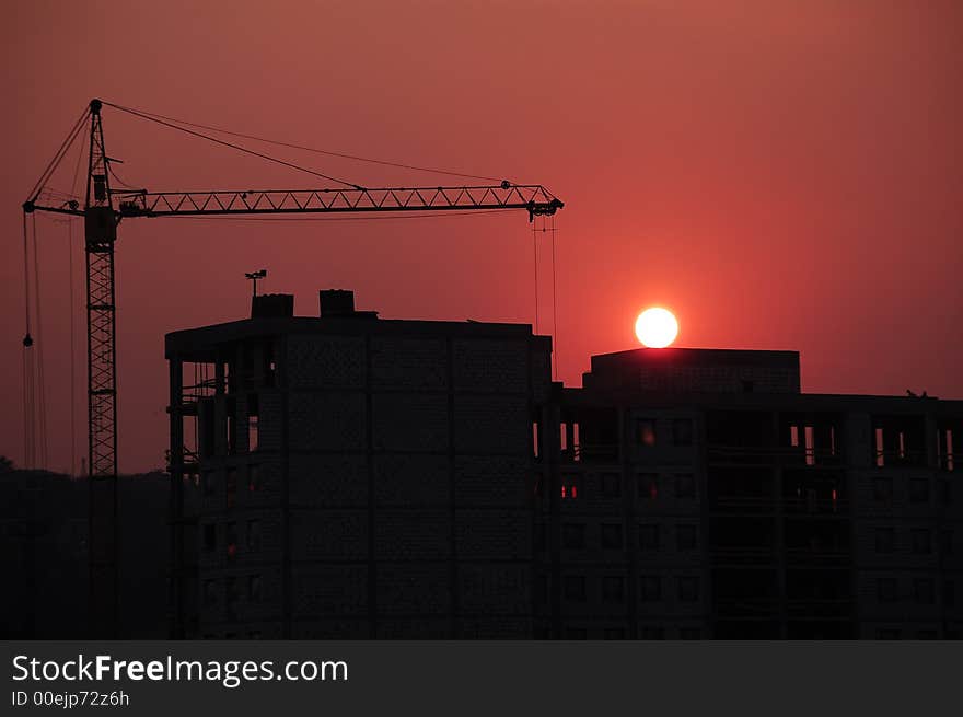 Construction Site Sillouhette with tower Crane at Sunset. Construction Site Sillouhette with tower Crane at Sunset