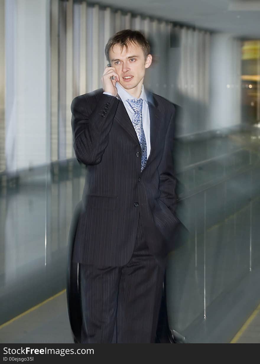 Businessman speaking by the phone with effect motion blur (Effect has been received by means of zoom an objective)