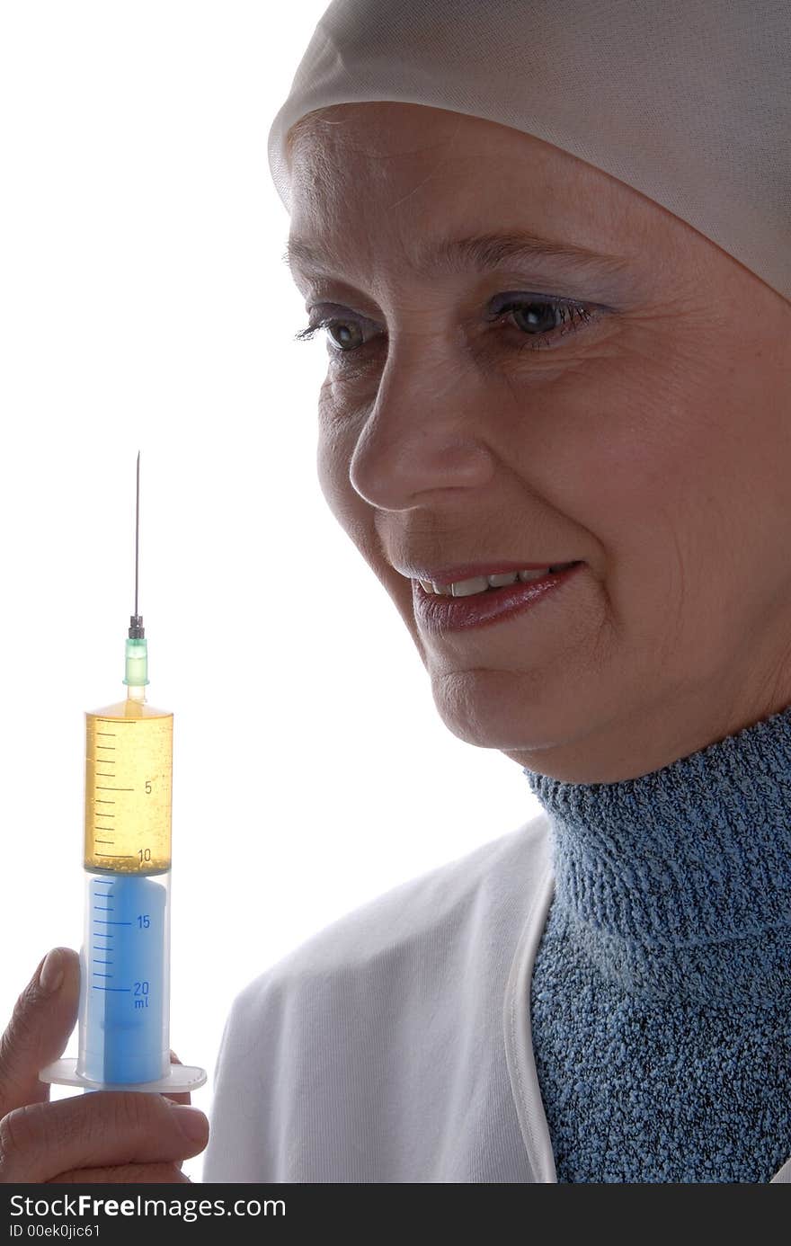 Kind smiling nurse with full of medicine big syringe