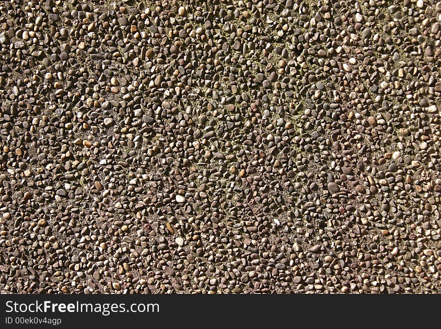 Wall made of concrete and little pebbles as background. Wall made of concrete and little pebbles as background