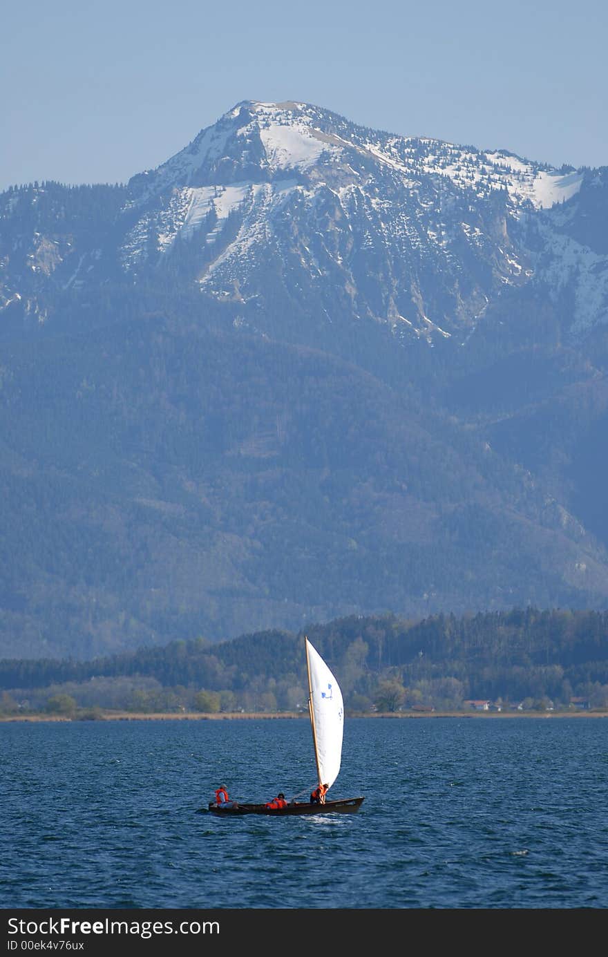 Sailing ship in the Alps lake at the morning