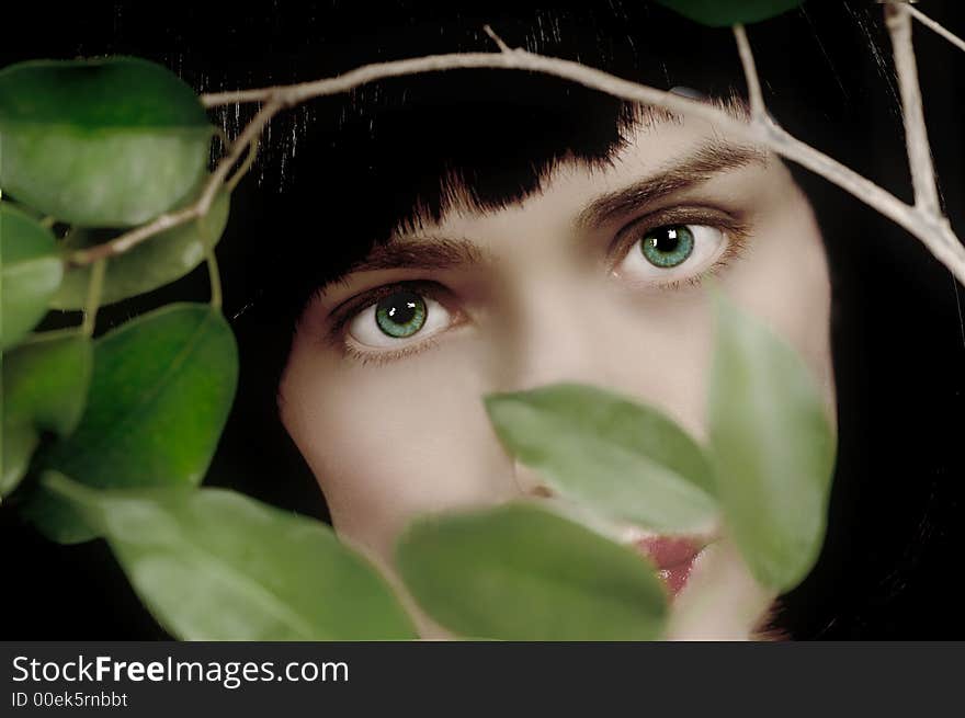 Beautiful High fashion Model posing between the leaves. Beautiful High fashion Model posing between the leaves