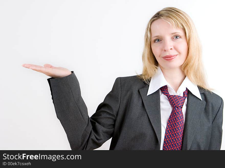 A blond business woman in a suit and tie with her palm turned upwards. A blond business woman in a suit and tie with her palm turned upwards