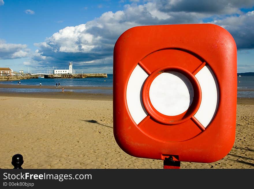 Lifebuoy ring with a lighthouse in the background