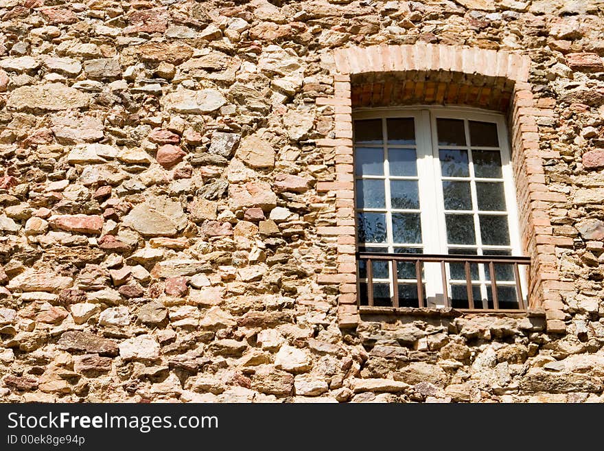 Old stone wall with a window