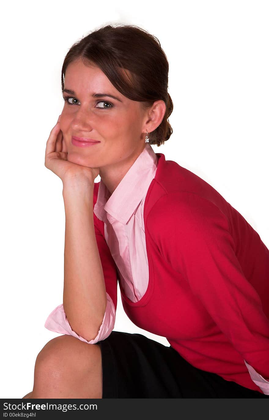 Young lady with hand on knee and chin, red sweater, pink top looking at the camera. White isolated back ground. Young lady with hand on knee and chin, red sweater, pink top looking at the camera. White isolated back ground.