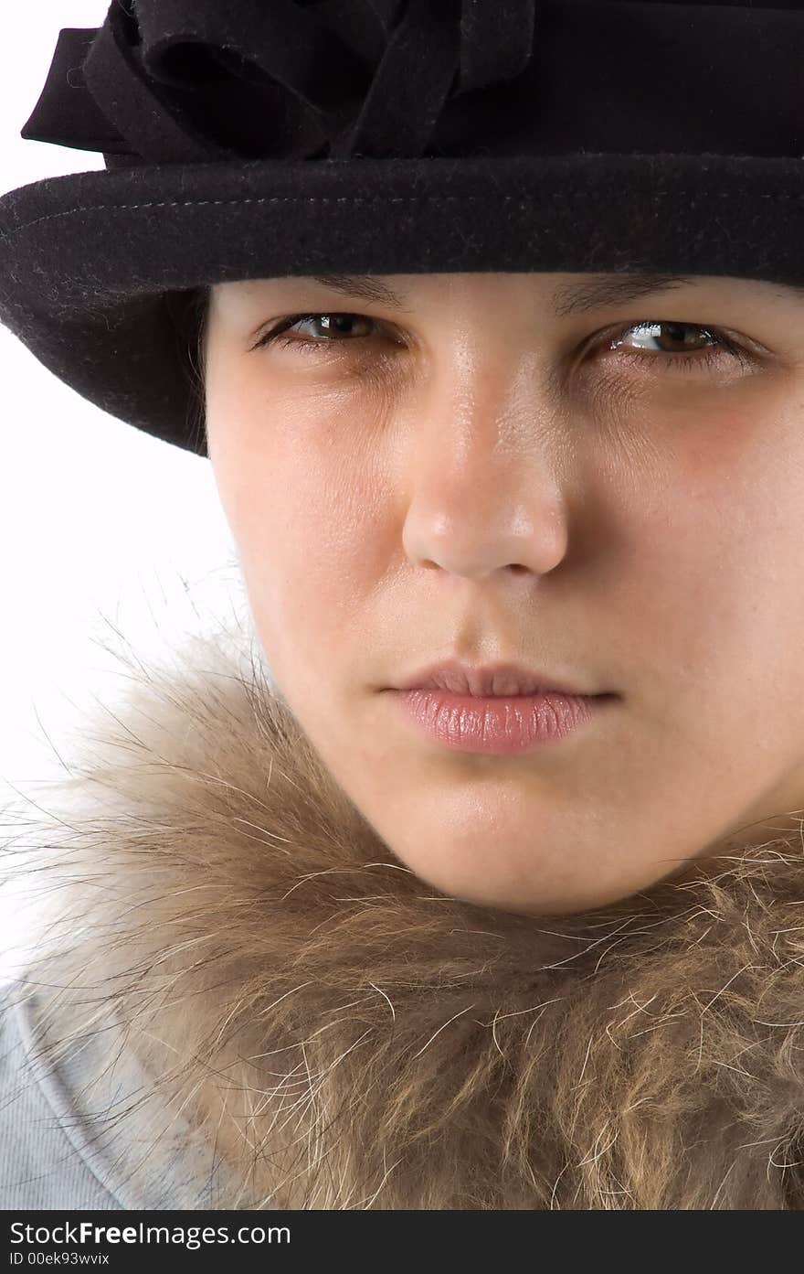 The girl in a hat steadfastly looks at the photographer. The girl in a hat steadfastly looks at the photographer