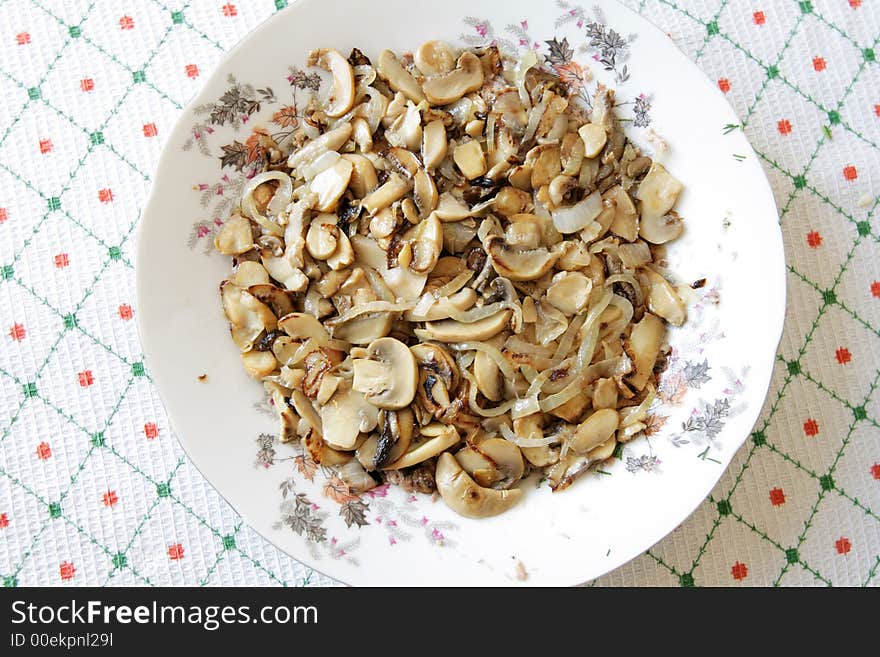 Fried mushrooms in a plate decorated by colors