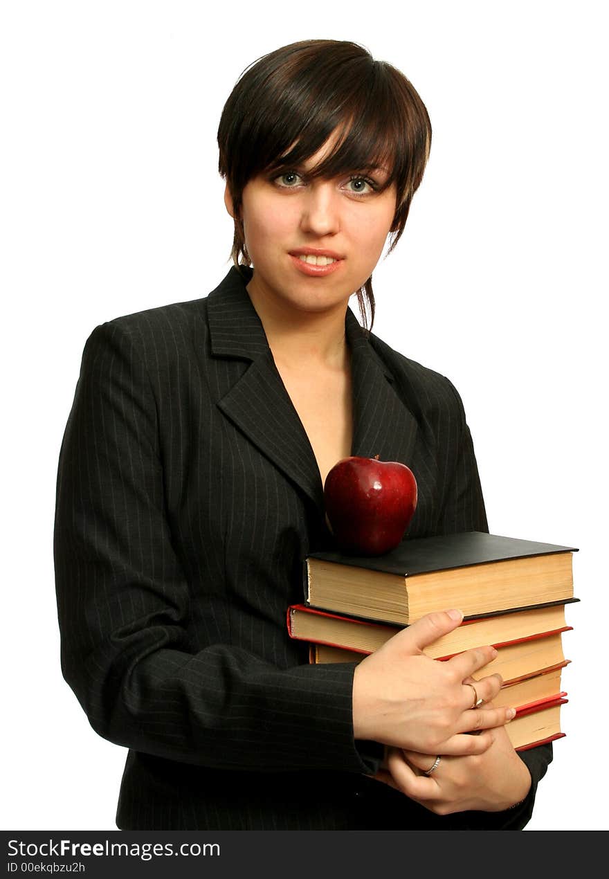 The young girl with books and a red apple, isolated on white