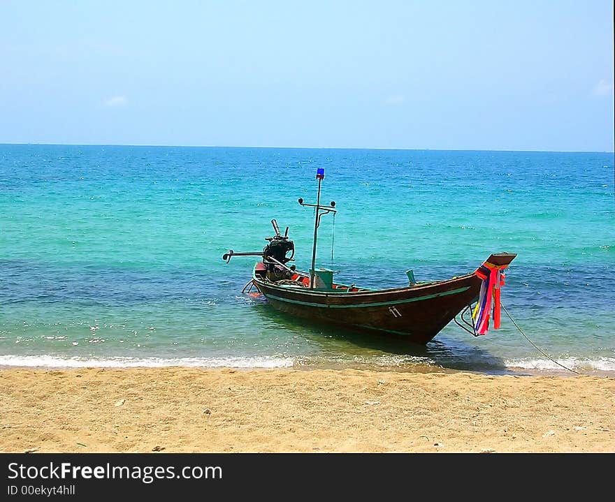 Thai longtailboat with bright ribbons in turquoise waters