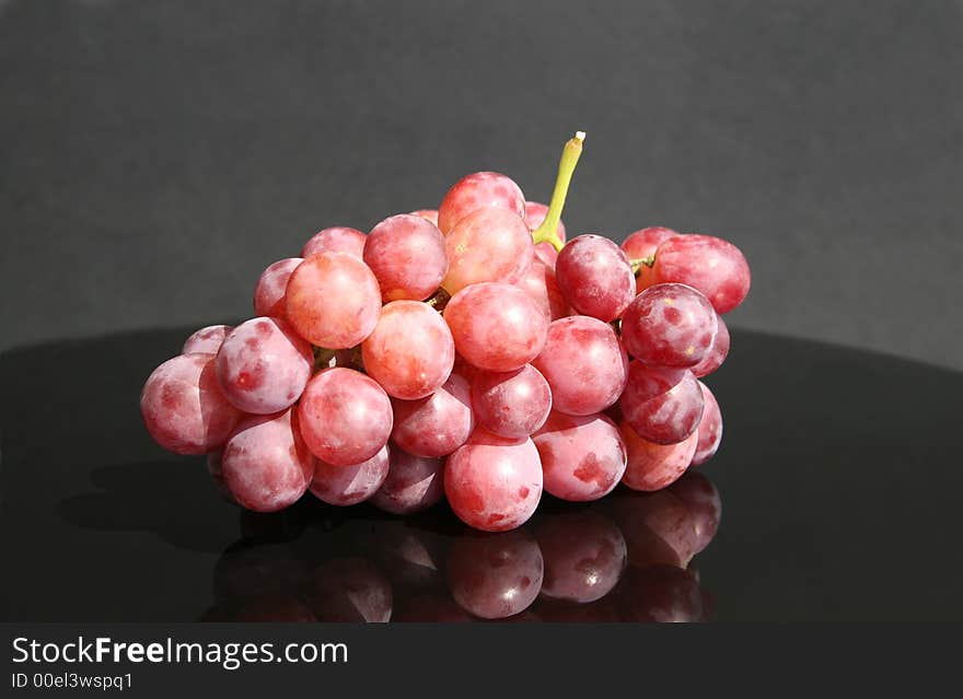 Cluster of red grape on the table