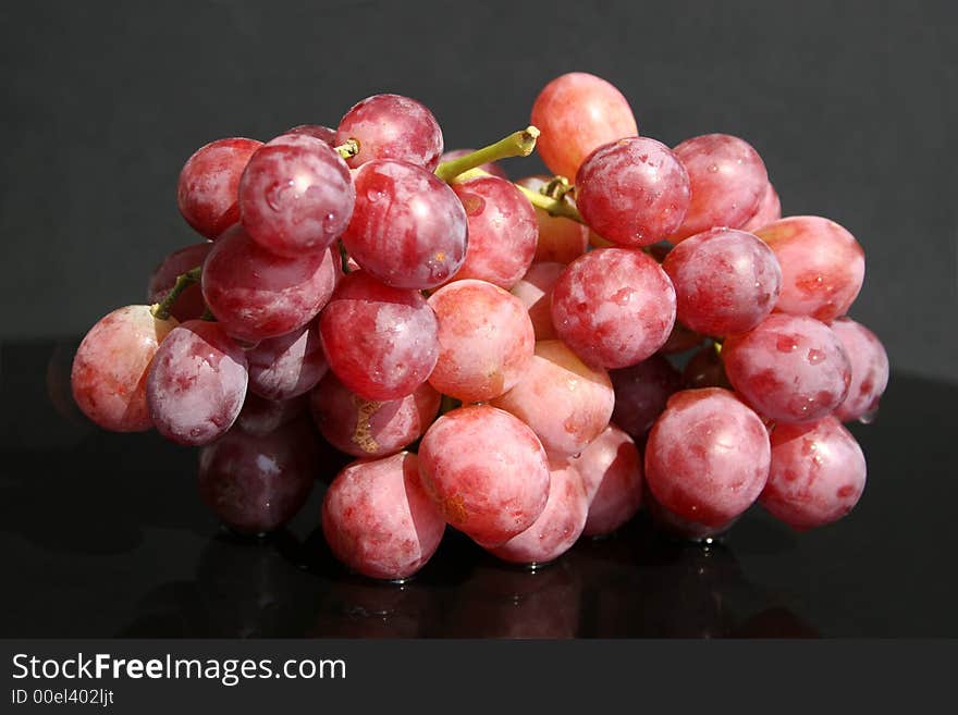 Cluster of red grape on the table