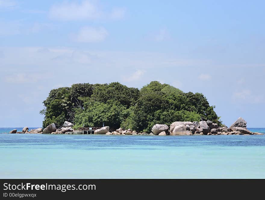 Tiny private island covered in lush tropical vegetation 300 metres off Cote D'Or beach, Praslin. Tiny private island covered in lush tropical vegetation 300 metres off Cote D'Or beach, Praslin