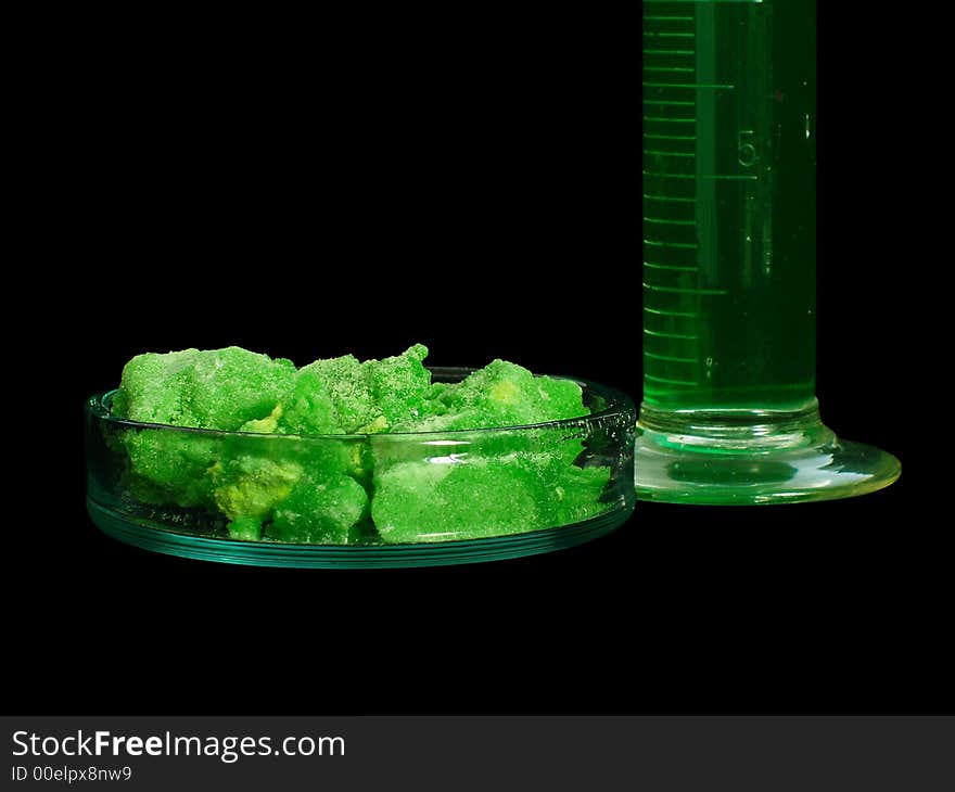 Laboratory glass filled in colorful liquids isolated on black background