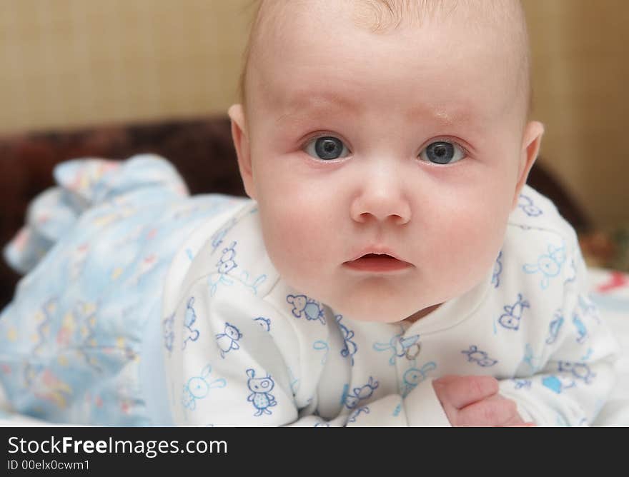 Portrait of the child close up, interestedly looking in an objective. Portrait of the child close up, interestedly looking in an objective