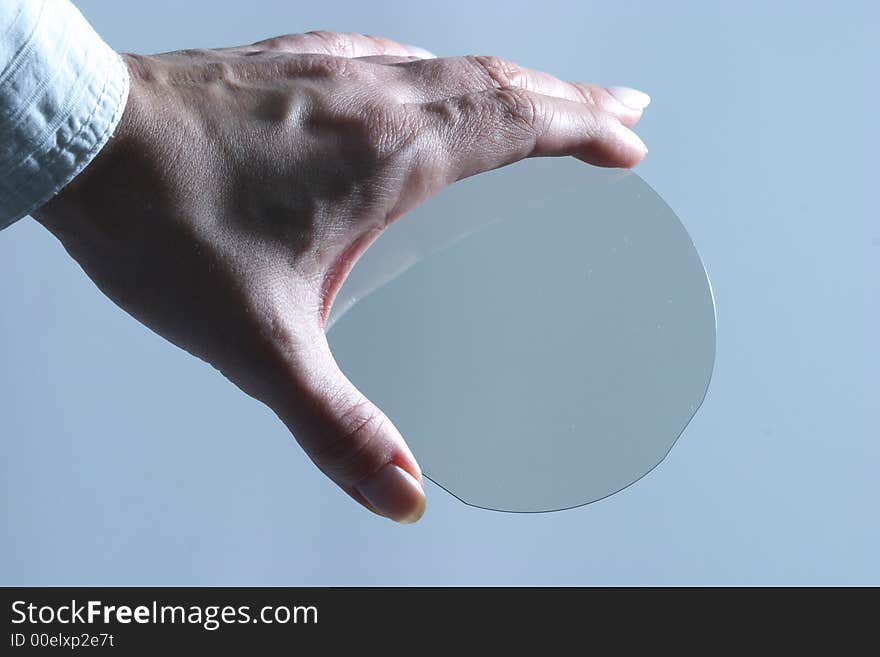 Translucent microchip plate in womans hand