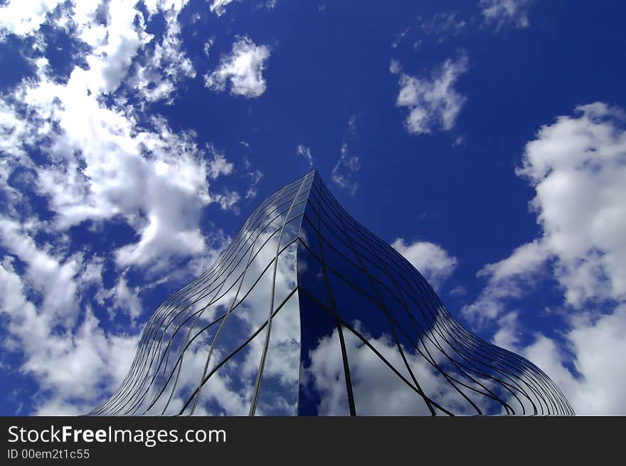 Office building details reflecting, blue sky and clouds in windows. Office building details reflecting, blue sky and clouds in windows