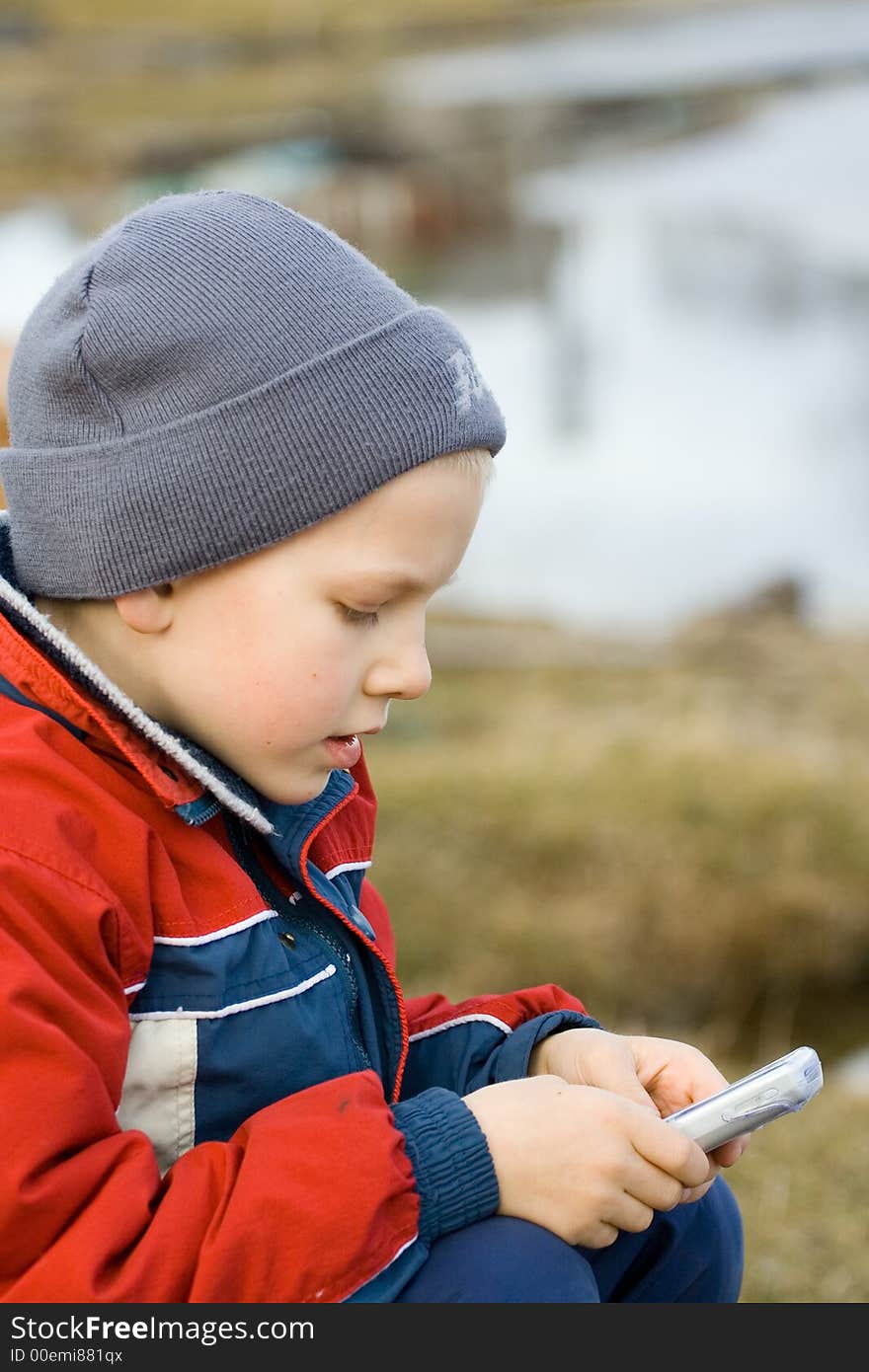 The boy considering mobile phone