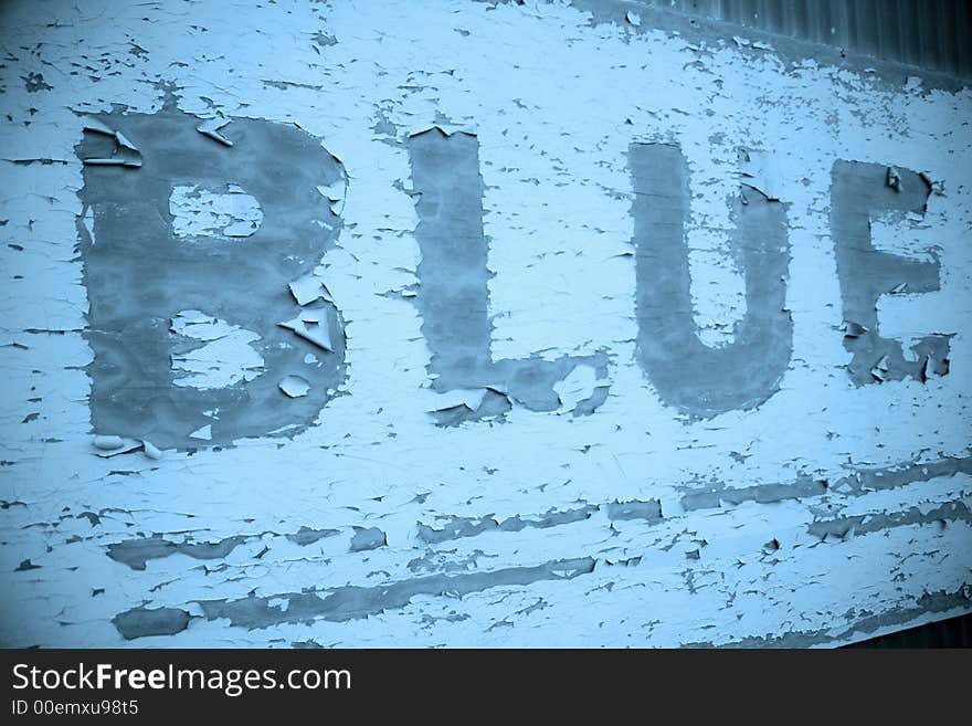 Old sign with peeling paint that says Blue. Old sign with peeling paint that says Blue