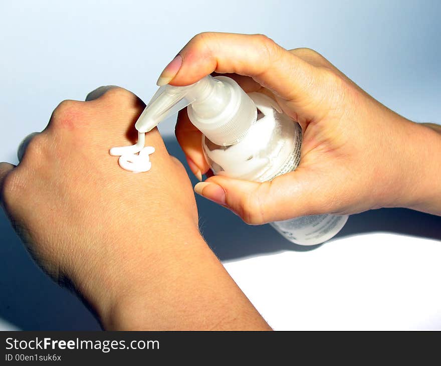 Girl`s hands with a cream.