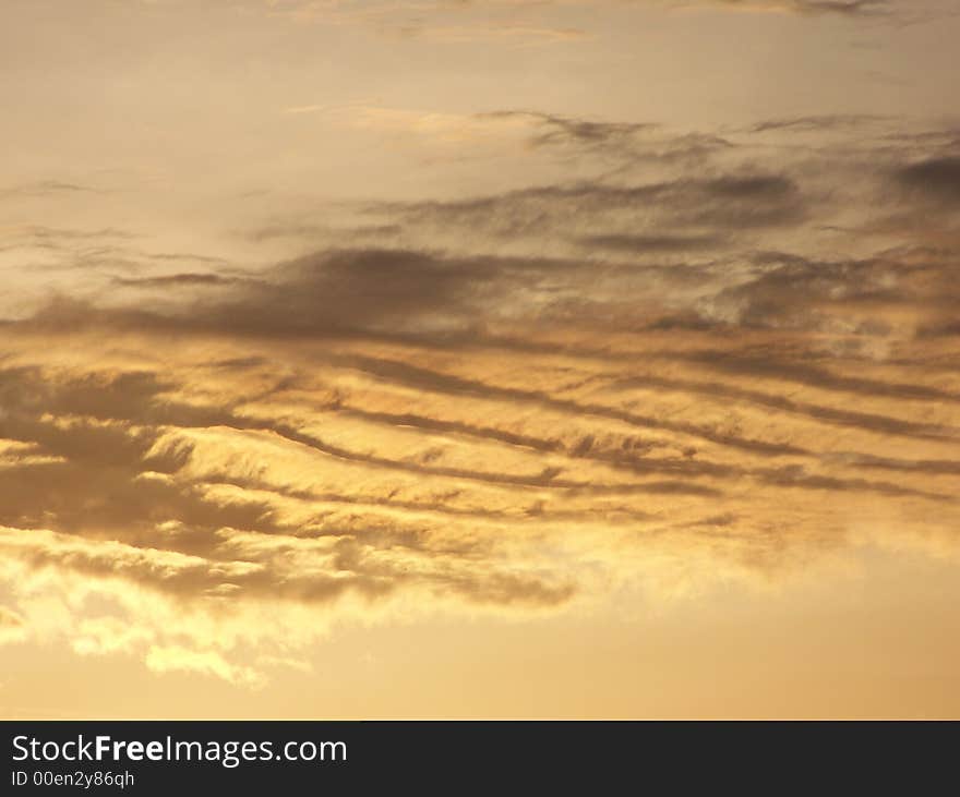 Streaky, golden, heavenly looking clouds at dawn. Streaky, golden, heavenly looking clouds at dawn.