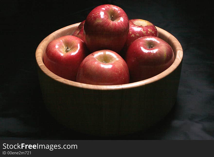 A bowl of healthy apples in low key lighting. A bowl of healthy apples in low key lighting.