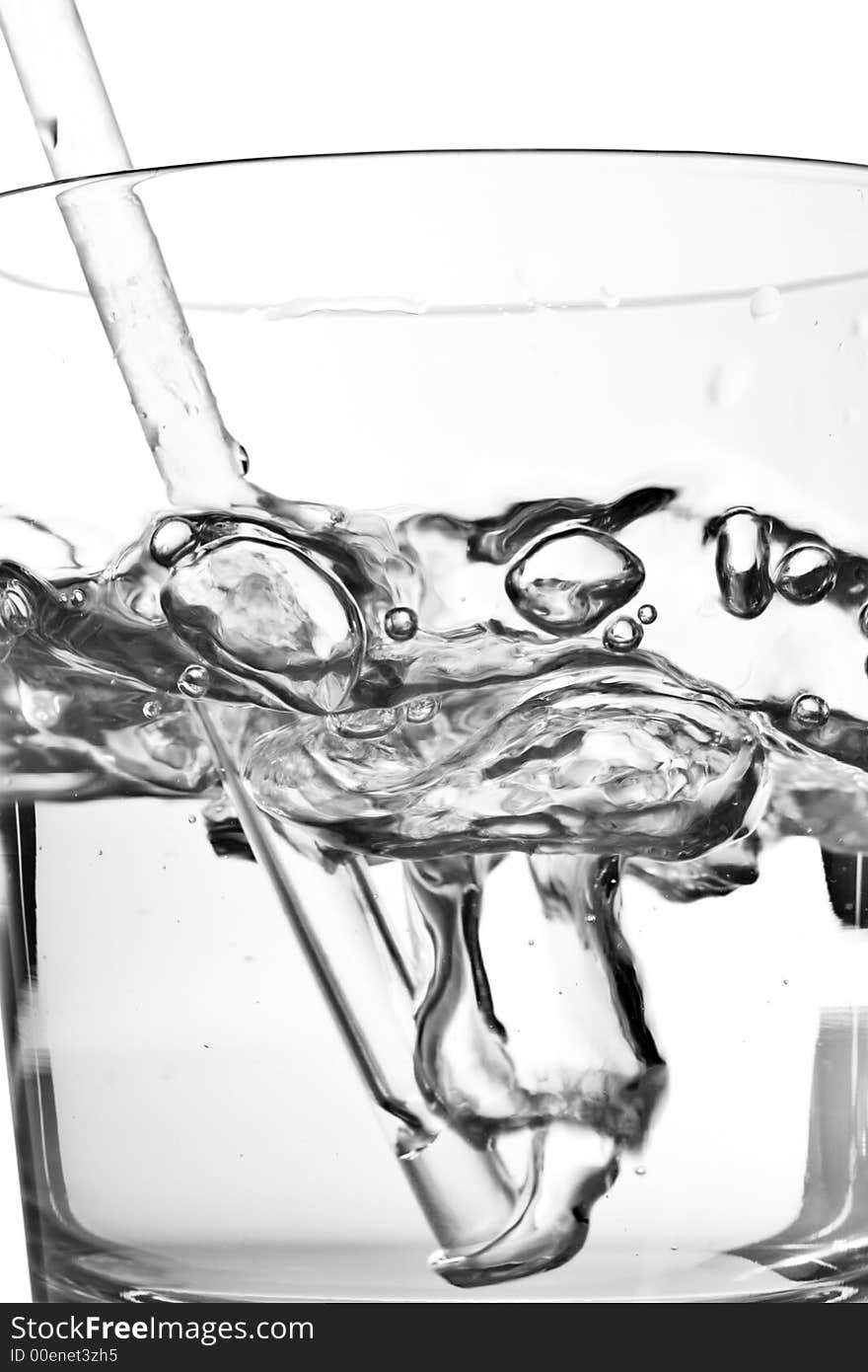 Blowing bubbles in a glass on white