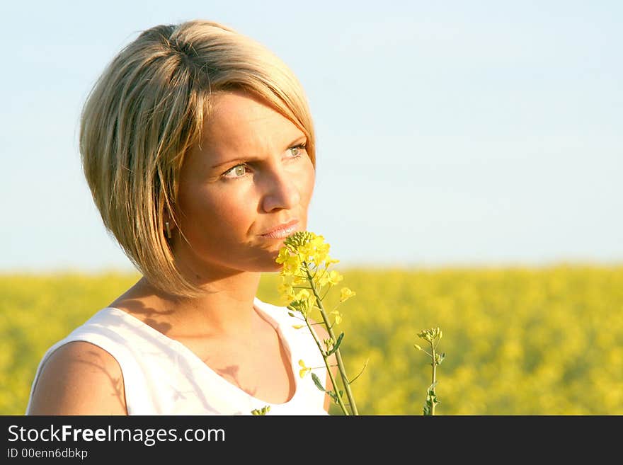 A beautiful young woman and yellow flowers. A beautiful young woman and yellow flowers