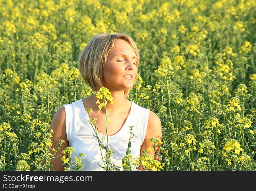 A beautiful young woman and yellow flowers. A beautiful young woman and yellow flowers