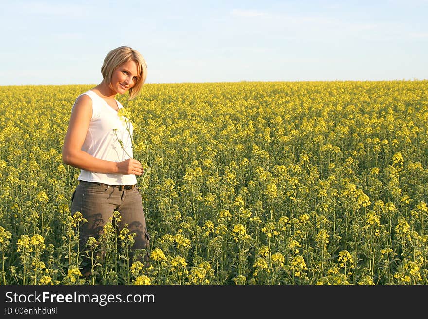 A beautiful young woman and yellow flowers. A beautiful young woman and yellow flowers