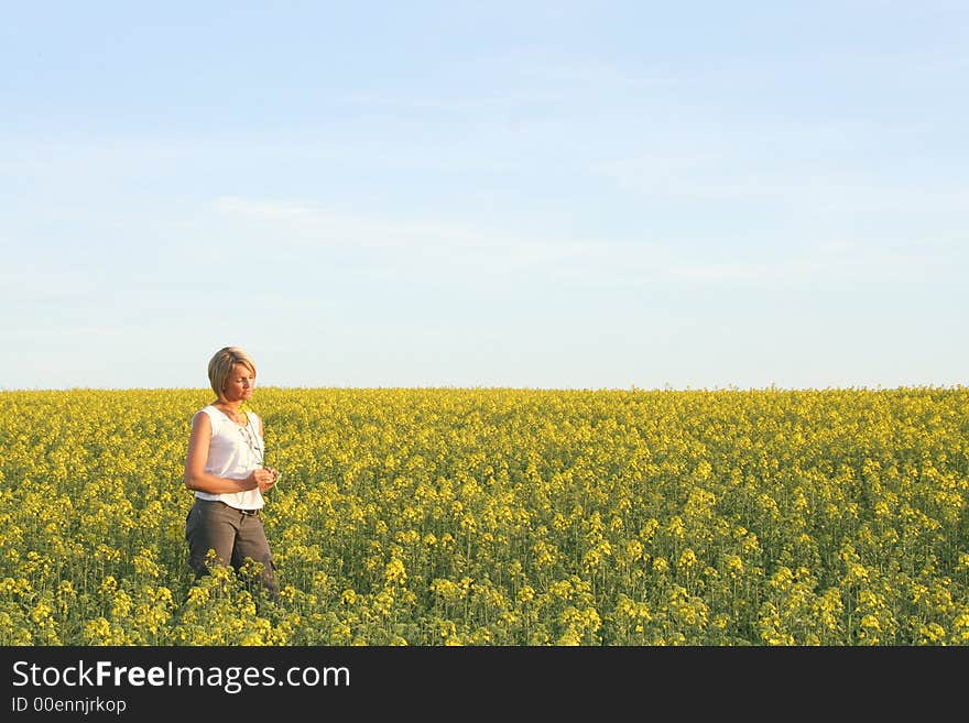 A beautiful young woman and yellow flowers. A beautiful young woman and yellow flowers