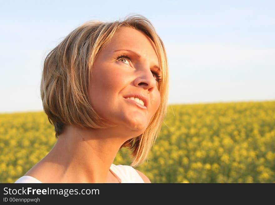 A beautiful young woman and yellow flowers. A beautiful young woman and yellow flowers