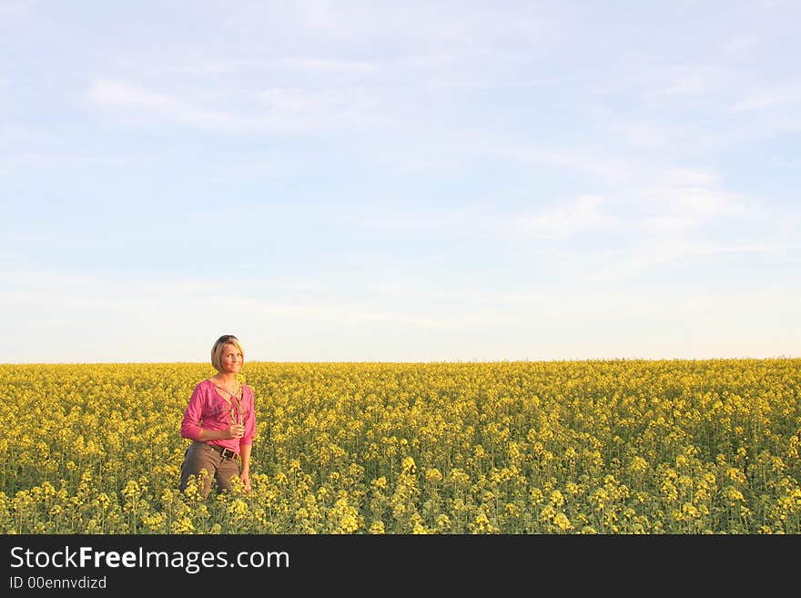 A beautiful young woman and yellow flowers. A beautiful young woman and yellow flowers