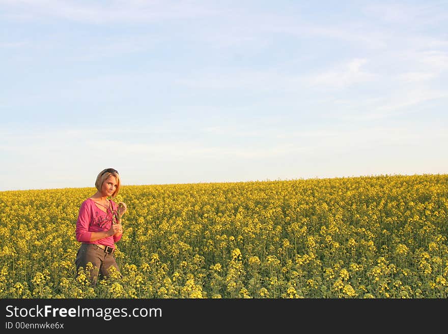 A beautiful young woman and yellow flowers. A beautiful young woman and yellow flowers