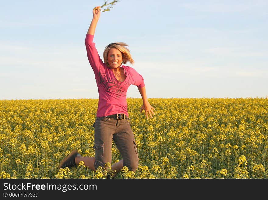 A beautiful young jumping woman and yellow flowers. A beautiful young jumping woman and yellow flowers