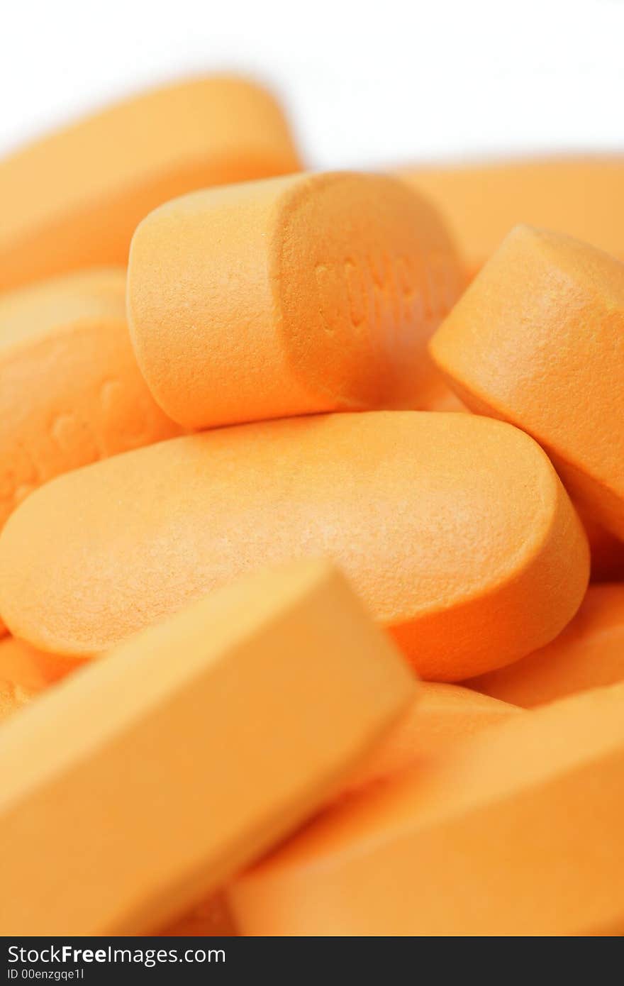 Pills over white background. Soft focus. Orange Color.