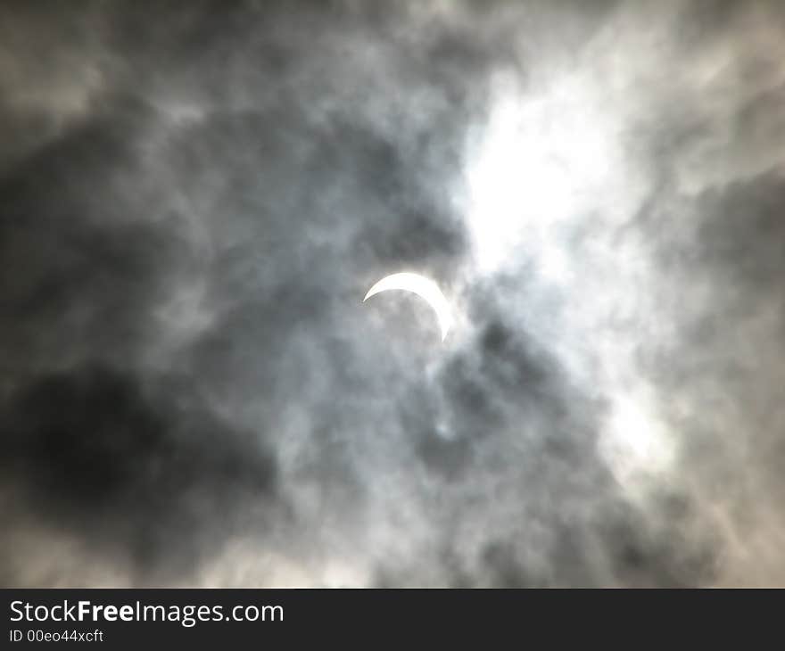 Partial solar eclipse in the clouds. Ukraine. March 29, 2006.