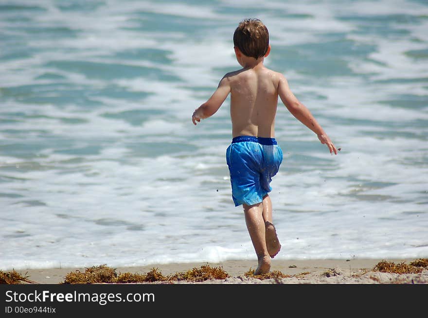 Little boy playing at the beach. Little boy playing at the beach.