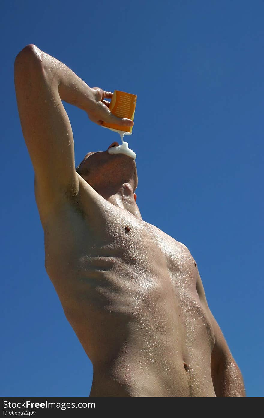 Guy drinking cold beer after have taken a bath to cool down and enjoy the summer sun. Guy drinking cold beer after have taken a bath to cool down and enjoy the summer sun