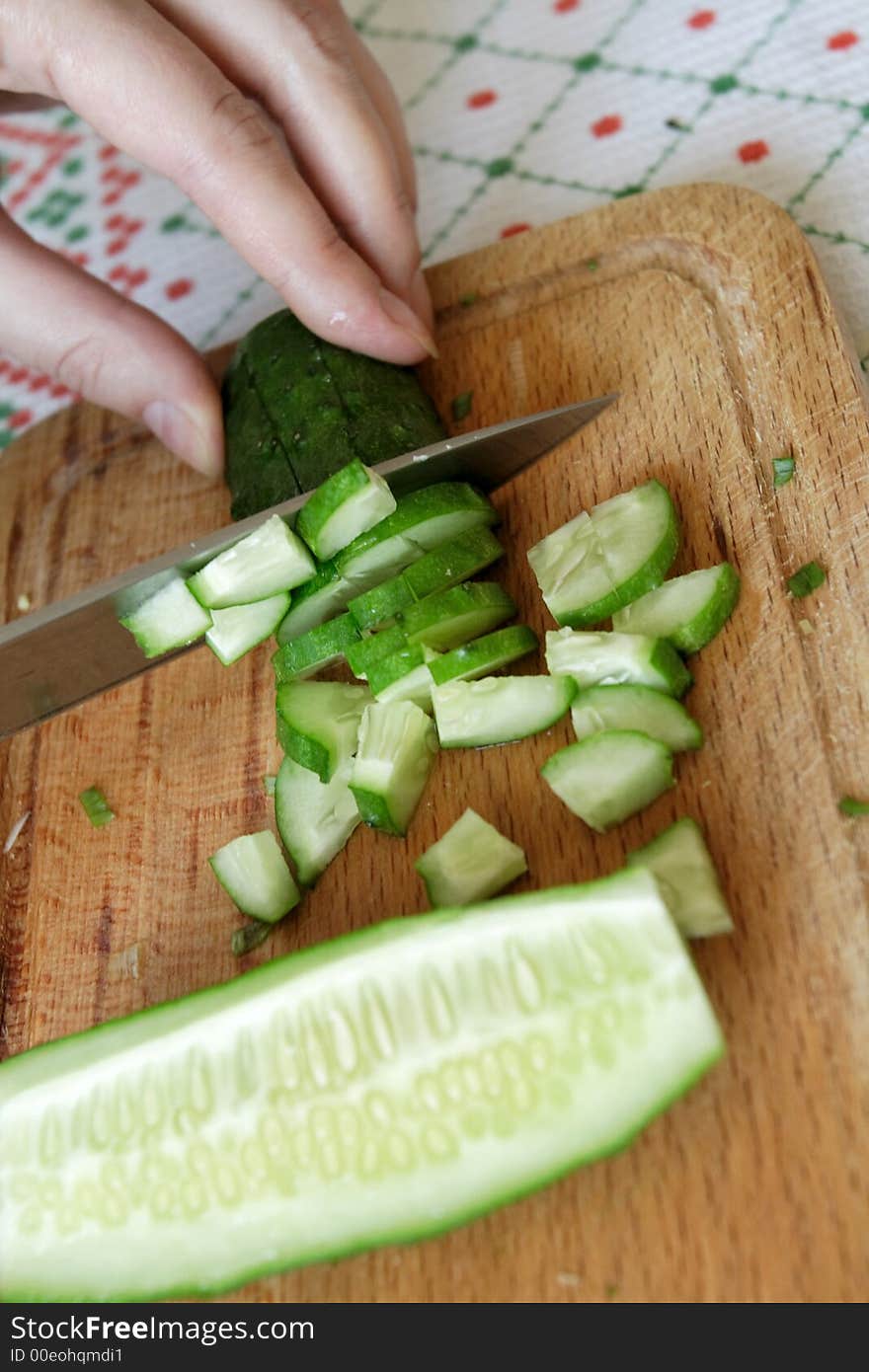 Cutting of cucumberon wooden a plate