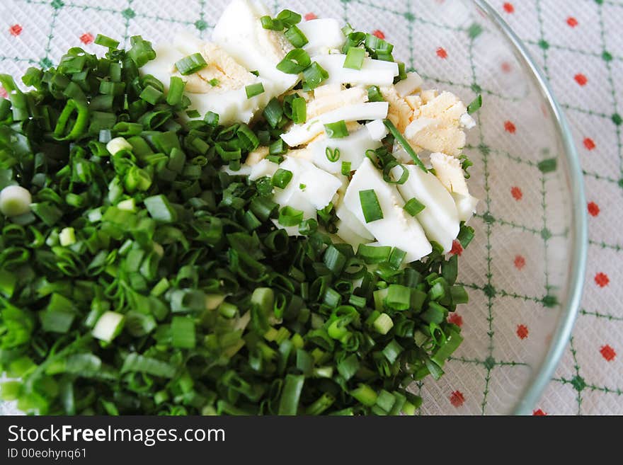 Salad with eggs in a glass plate